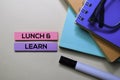 Lunch and Learn text on sticky notes isolated on office desk Royalty Free Stock Photo