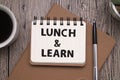 Lunch and Learn, text words typography written on book against wooden background, life and business motivational inspirational Royalty Free Stock Photo