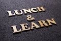 Lunch and Learn. wooden lettering typography concept Royalty Free Stock Photo