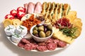 Lunch meal or appetiser with a single dish of salami, pepperoni, brie cheese, ham. Dinner plate or appetizer with salumi, cheeses Royalty Free Stock Photo