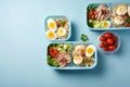 lunch meal in a blue lunch box with salad and boiled eggs. Generative AI