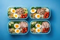 lunch meal in a blue lunch box with salad and boiled eggs. Generative AI