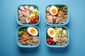 lunch meal in a blue lunch box with salad and boiled eggs. Generative AI