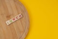 Lunch Menu Concept. Scrabble Letter Tiles On Wooden Table. Yellow Background