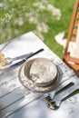 Serving table with dishware and silverware outdoors in nature Royalty Free Stock Photo