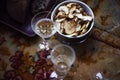 Lunch Provencal style still life with champagne in glasses on table, flower pattern, bread, apples, daylight.