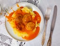 white round plate with meatballs sprinkled with chopped dill in tomato sauce with mashed potatoes Royalty Free Stock Photo