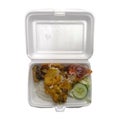 Lunch of rice with fried chicken called ayam penyet on a styrofoam container