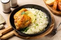 Lunch, Roasted chicken thighs and rice with lemon Royalty Free Stock Photo