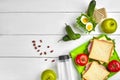 Lunch. Sandwich and fresh vegetables, bottle of water, nuts and fruits on white wooden background. Healthy eating Royalty Free Stock Photo