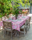 Lunch table with empty dish set on colorful tablecloth and bouquet of freshly picked garden flowers Royalty Free Stock Photo