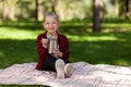 Lunch thermos. Cute little girl on a picnic in the park eats vegetables. Healthy food