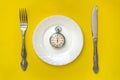 Lunch time concept. Clock with knife and fork Royalty Free Stock Photo