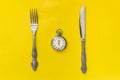 Lunch time concept. Clock with knife and fork Royalty Free Stock Photo