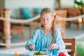 Adorable little girl having dinner at outdoor cafe Royalty Free Stock Photo