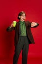 Lunch time. Studio footage young man, student or office clerk in vintage fashion style costume, suit posing isolated on Royalty Free Stock Photo
