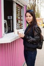 Lunch time. Young woman buying coffee Royalty Free Stock Photo