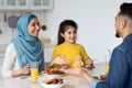 Lunch Together. Arab Family With Little Daughter Eating Tasty Food In Kitchen Royalty Free Stock Photo