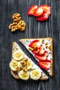 Lunch with triangle sandwiches on dark table background top view