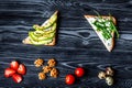 Lunch with triangle sandwiches on dark table background top view