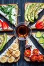 Lunch with triangle sandwiches on dark table background top view