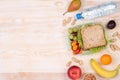 Lunchbox with sandwich, fruits, vegetables, and water with copy space Royalty Free Stock Photo