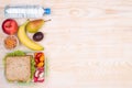 Lunchbox with sandwich, fruits, vegetables, and water Royalty Free Stock Photo