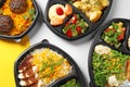 Lunchboxes with different meals on color table. Healthy food delivery