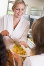 Lunchlady serving plate of lunch in a school