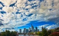 Lunchtime sky with many small white clouds in front of the blue armament and the skyline of a big city with skyscrapers in the Royalty Free Stock Photo