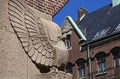 Stone eagle sitting in a street corner on building