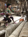 Lung Tam, Vietnam - January 9, 2020 - Woman weaving in a traditional way, focus on the lin and the loom