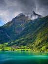 Lungern, canton of Obwalden, Switzerland. A view of rural homes in a green meadow. A lake in a mountain valley. Royalty Free Stock Photo