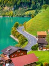 Lungern, canton of Obwalden, Switzerland. A view of rural homes in a green meadow. A lake in a mountain valley. Royalty Free Stock Photo