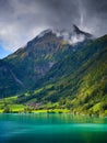 Lungern, canton of Obwalden, Switzerland. A view of rural homes in a green meadow. A lake in a mountain valley. A popular place to Royalty Free Stock Photo