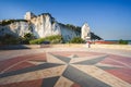 Lungomare seafront of Vieste in Gargano with windrose symbol designed on the ground and the Pizzomunno white rock on background