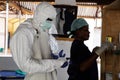 Lunsar, Sierra Leone - April 29,2015: a nurse and medical worker prepare to enter dangerous zone of an ebola treatment center to Royalty Free Stock Photo