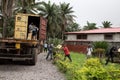 Lunsar, Sierra Leone - June 9, 2015: African community volunteers help unload boxes from a humanitarian aid truck in an African Royalty Free Stock Photo