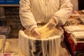 Cook preparing flour noodles at a street vendor restaurant in Luoyang, China