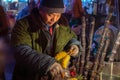 Man cutting and selling pineapple on street food fruit stall in Luoyang, China