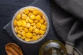 Lupini beans in brine. Pickled lupin in bowl on black table. Top view Royalty Free Stock Photo