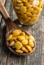 Lupini beans in brine. Pickled lupin in spoon on wooden table Royalty Free Stock Photo