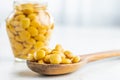 Lupini beans in brine. Pickled lupin on wooden spoon on kitchen table Royalty Free Stock Photo