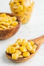 Lupini beans in brine. Pickled lupin on wooden spoon on kitchen table Royalty Free Stock Photo