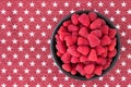 Luscious fresh picked raspberries in a large black ceramic bowl on a background of white stars on a field of red, top view Royalty Free Stock Photo