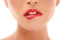 Luscious lips. A young woman biting her lip wearing red lipstick - cropped. Royalty Free Stock Photo