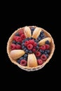 Luscious-looking pastries with bright blueberries and raspberries against dark background