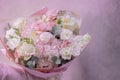 A lush beautiful bouquet of light pink, white cute delicate small roses of different sizes, flowers of green leaves. Royalty Free Stock Photo
