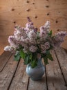 Lush bouquet of lilacs in a blue ceramic vase