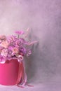 A lush bouquet of pink, purple, peach colour, white cute delicate small roses of different sizes, flowers in cylindrical box Royalty Free Stock Photo